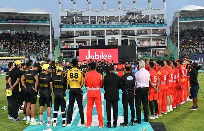 Players and match officials gather around to observe a minute of silence for the victims of the terror attack in New Zealand on March 15, 2019.