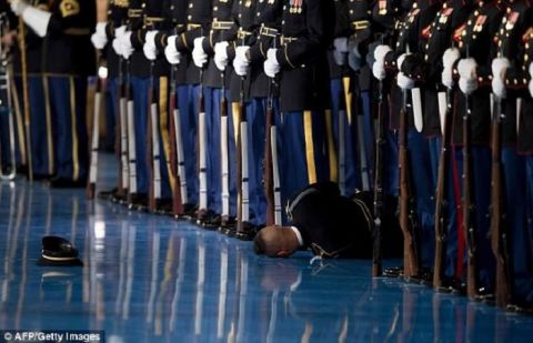 Member of U.S. Army honor guard passes out