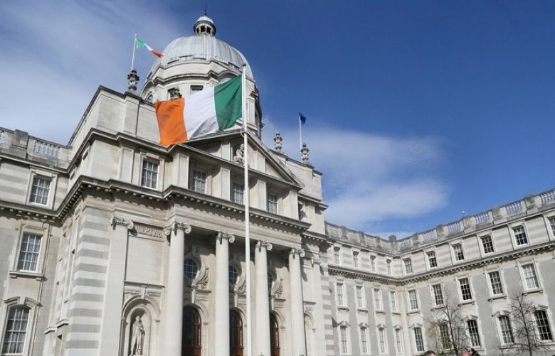An Irish national flag flies outside the Government Buildings in Dublin, Ireland 