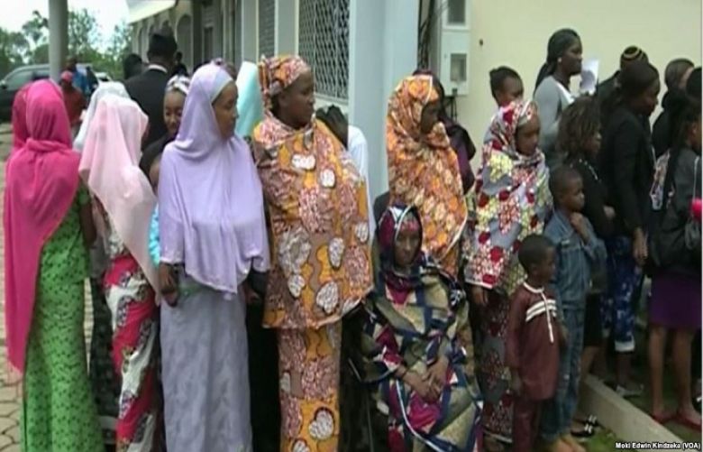 Internally displaced people line up to receive aid in Bamenda, April 3, 2019.