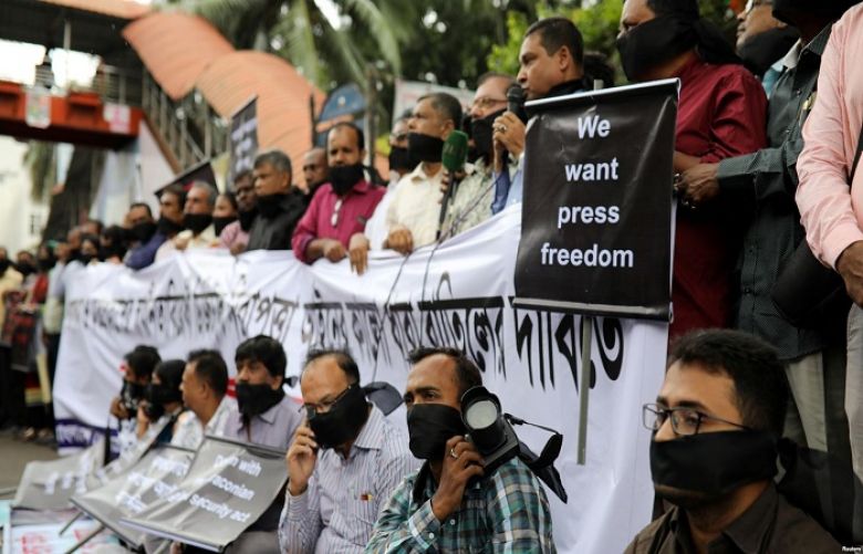Journalists hold banners and placards as they protest laws they fear are aimed at curbing press freedom in Dhaka, Bangladesh, Oct. 11, 2018. On Monday, Bangladesh shut down dozens of online news portals for several hours.